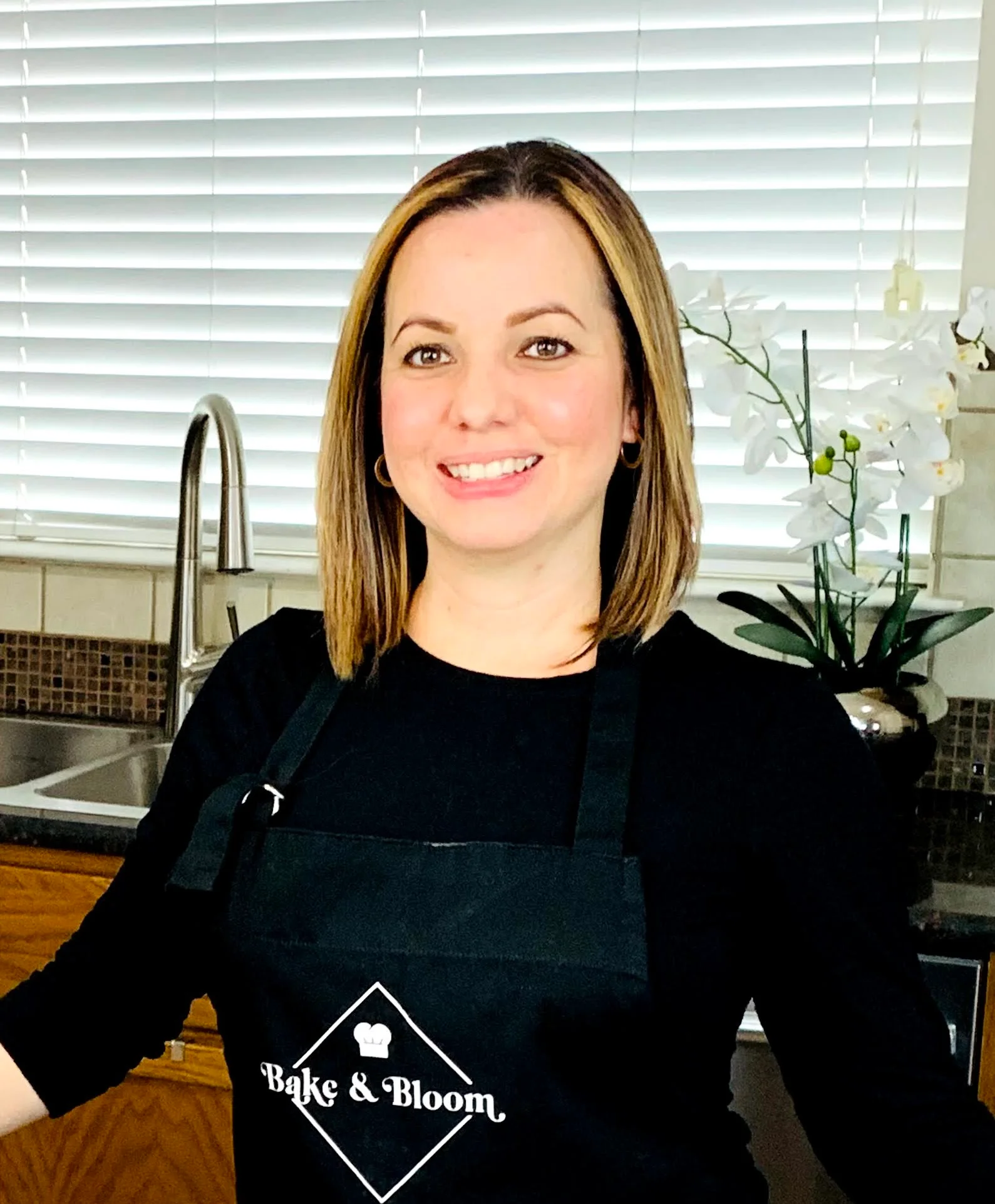 Baker in a sunlit home kitchen holding fresh flowers