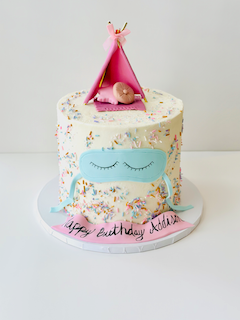 One tier birthday cake with sleeping eyes and teepee topper